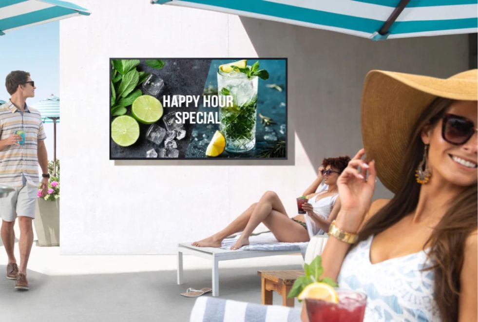 Resort Pool TV Resort guests relaxing by the pool while watching entertainment on a weatherproof outdoor TV, powered by an IPTV network.