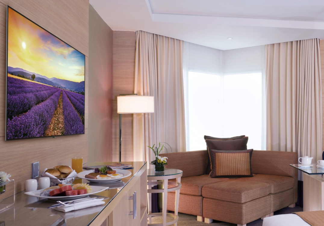 Peerless wall mount TV bracket installed in modern hotel guest room