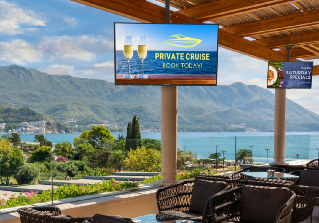 Peerless AV outdoor wall mount supporting TV at restaurant patio