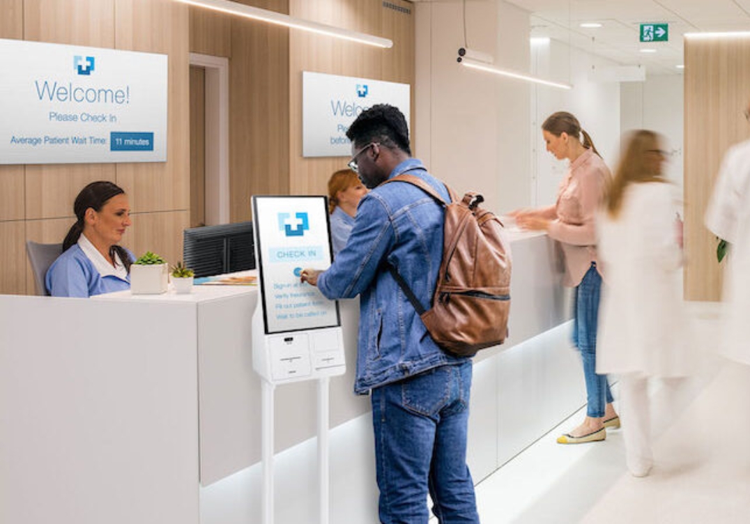 Peerless digital signage kiosk displaying welcome message in hospital lobby