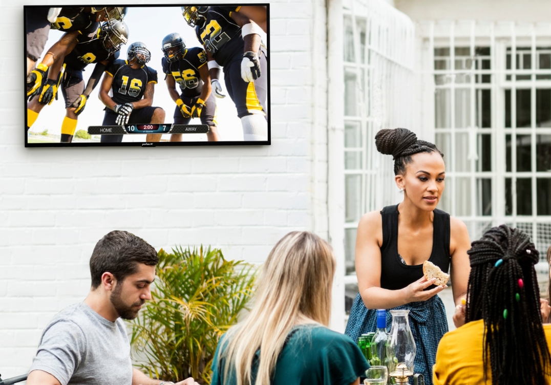 Peerless AV outdoor wall mount supporting TV at restaurant patio