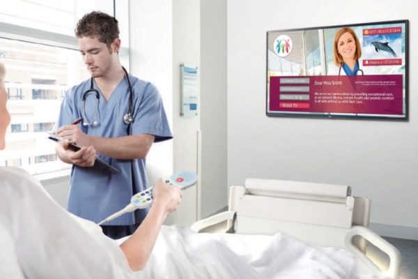 UL-listed LG Pro:Centric hospital TV installed in patient room with pillow speaker control on bed