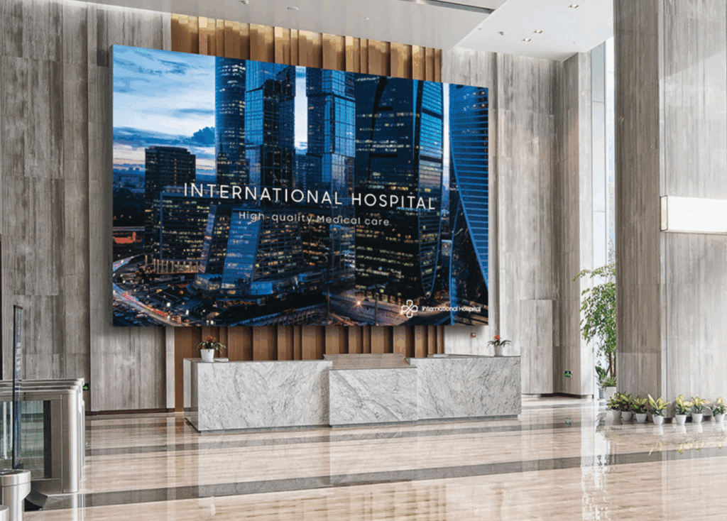 “Hospital lobby featuring a large LED welcome display supported by commercial AV systems for hospital downtime reduction.”