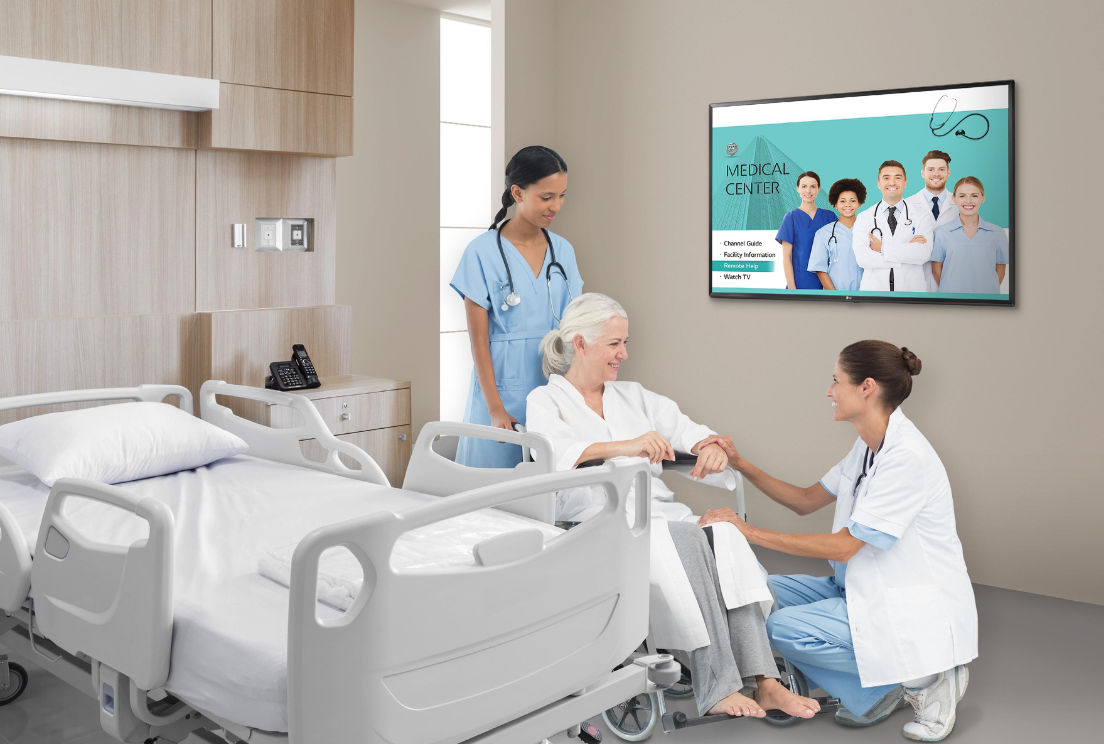 LG hospital TV displaying Pro:Centric welcome screen as part of a hospital patient TV system in a modern patient room