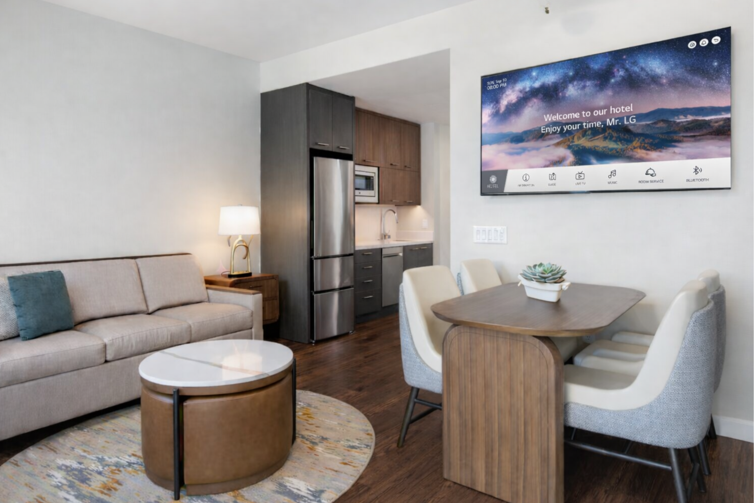 Residence Inn by Marriott extended stay suite featuring LG hospitality TVs in living area and bedroom, full kitchen with appliances, and guest room setup aligned with hotel brand standards