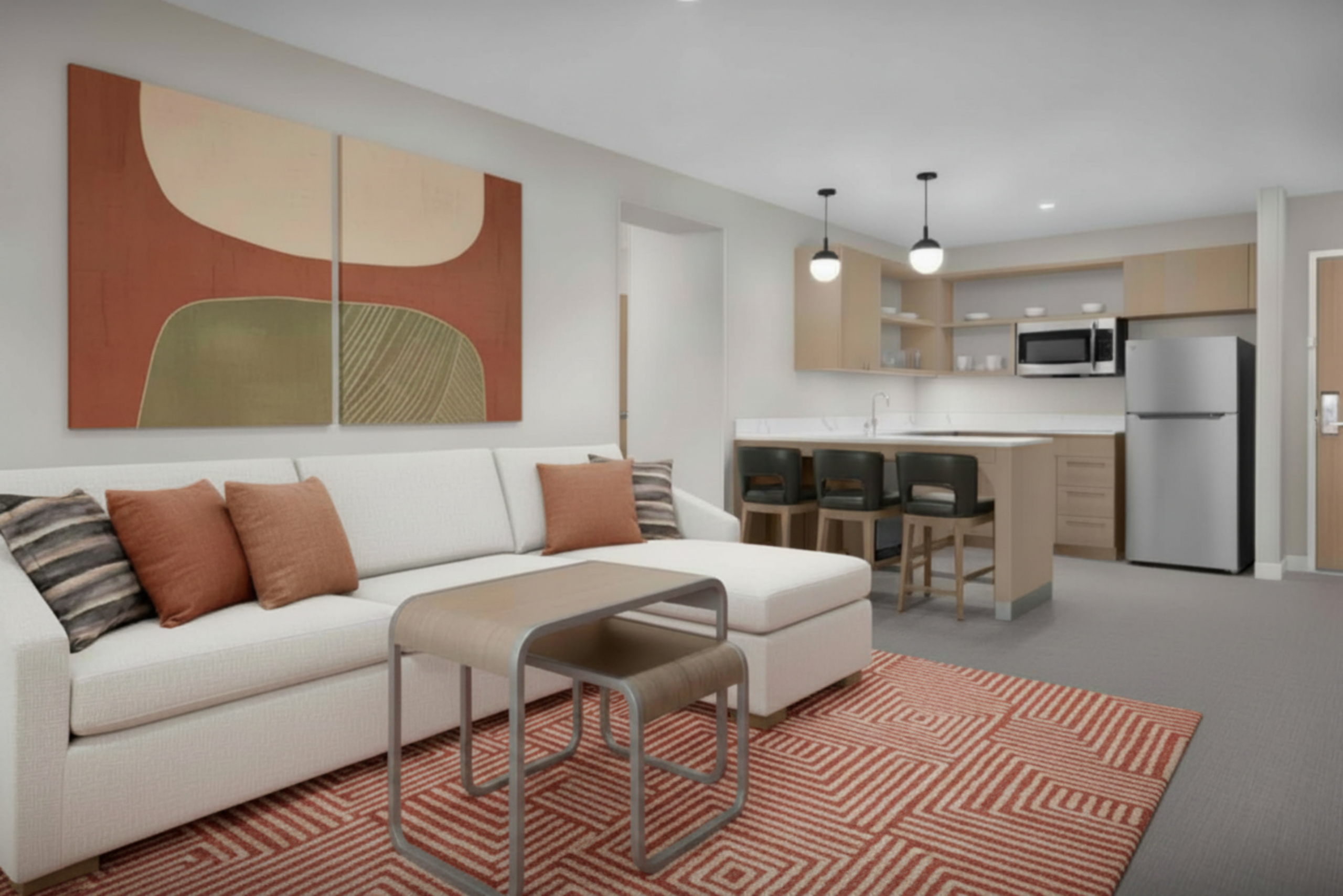 Homewood Suites by Hilton guest room with hospitality TVs, guest room appliances, stainless kitchen suite package, hotel brand standards bundle.